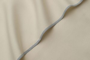 Folded genuine white Boski silk fabric showing its smooth, natural raw texture and signature subtle sheen.