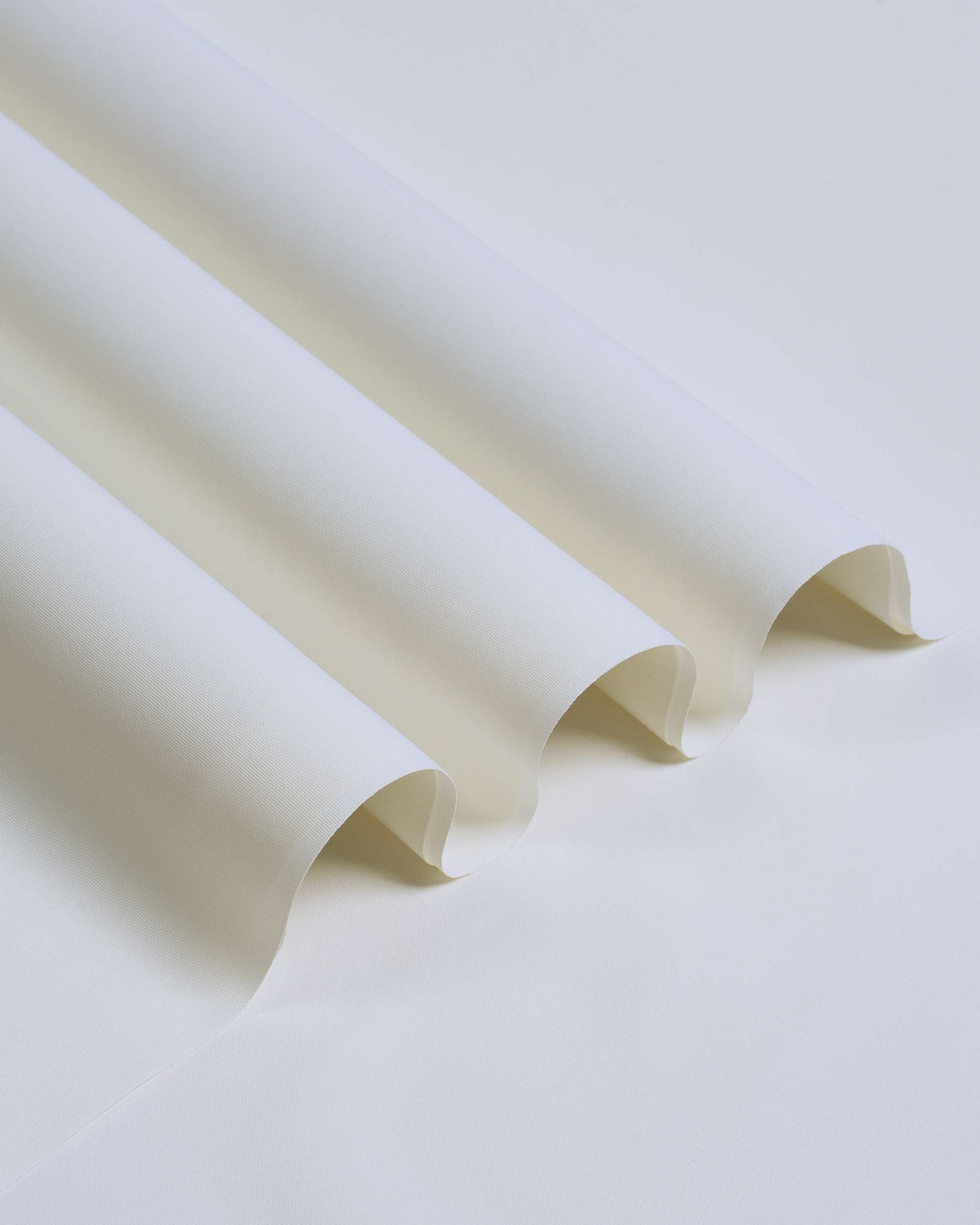 Ivory four-season unstitched suiting fabric folded with a smooth, crisp weave